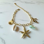 Bracelet doré charms étoile de mer coquillage perle Rklisa