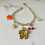 Bracelet doré breloque fleur cerise soleil et perle Rklisa